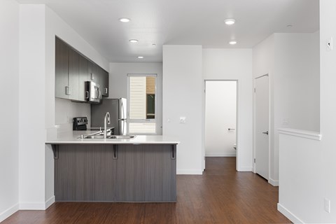 A kitchen with a sink and a refrigerator.
