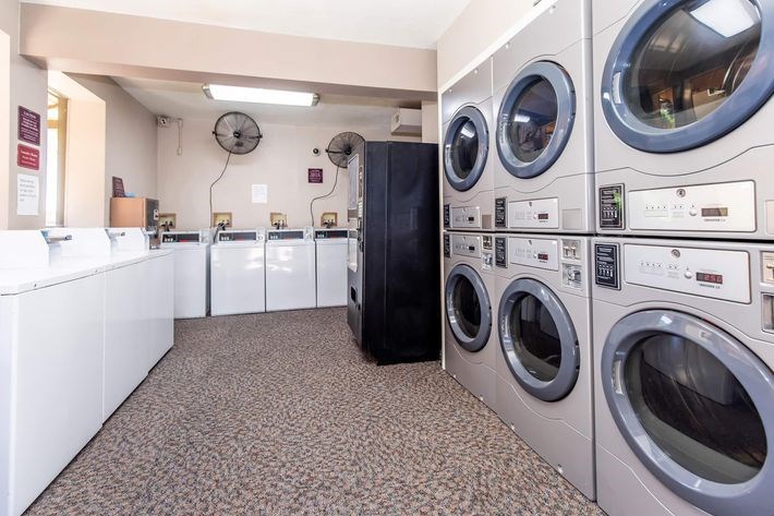 A row of washing machines in a laundromat.