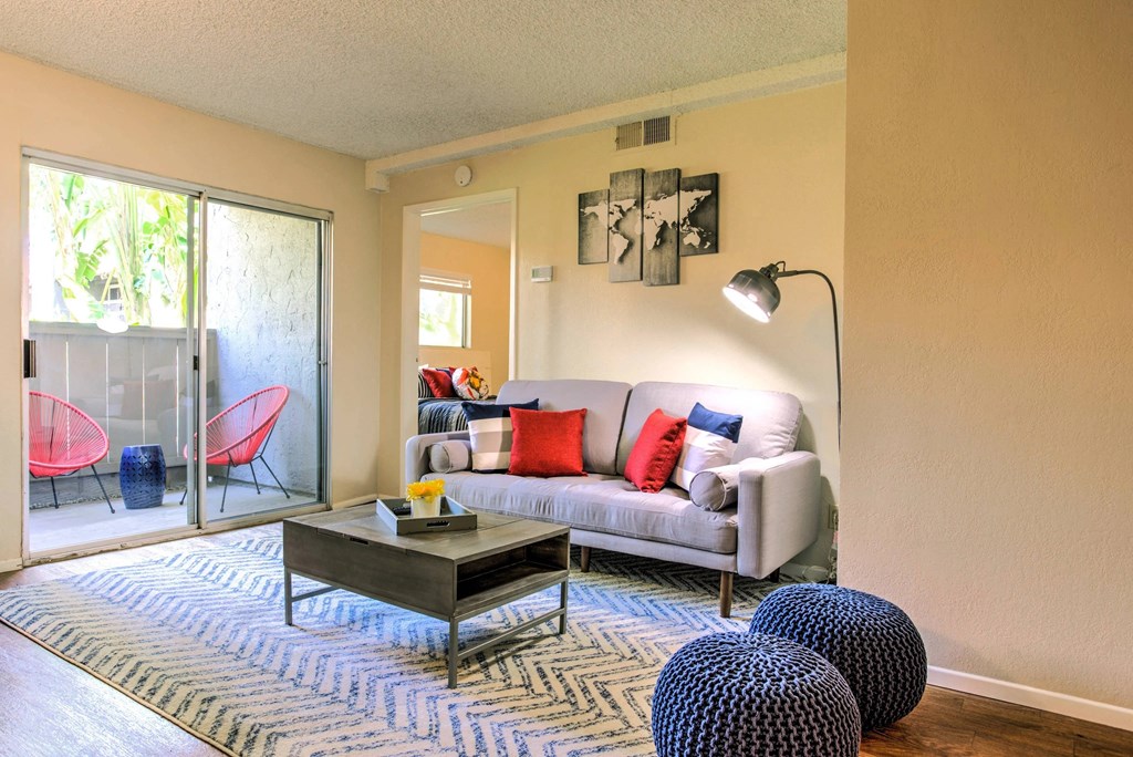 a living room with a couch and a coffee table and a sliding glass door