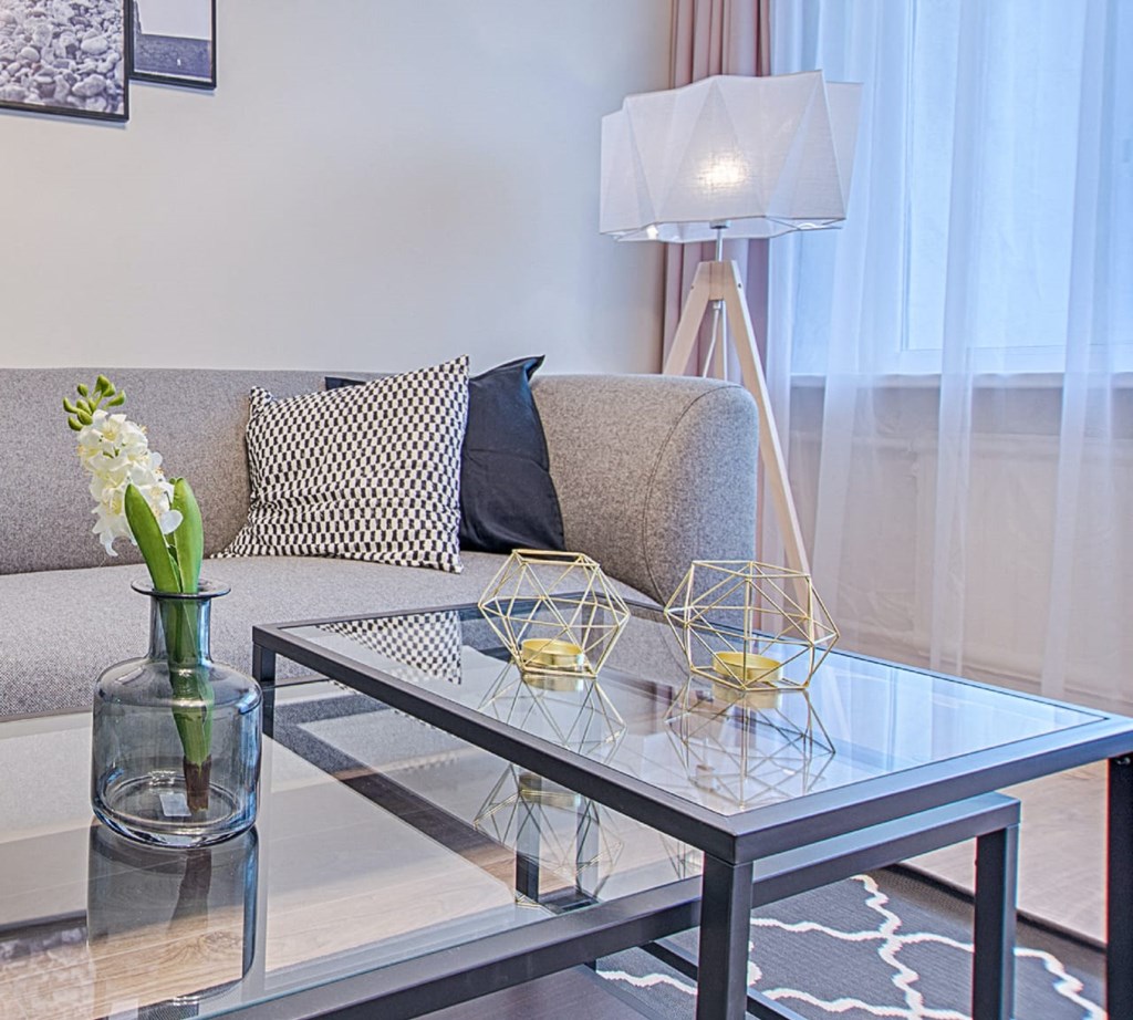 a living room with a couch and a glass table
