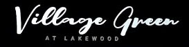 A black sign with the words "Village Green at Lakewood" written in white cursive.
