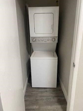 a white washer and dryer in a small room