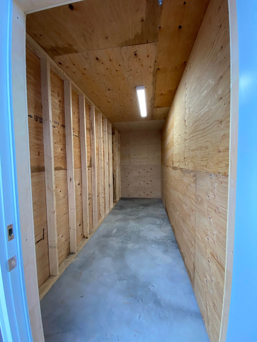 A room under construction with wooden walls and ceiling.