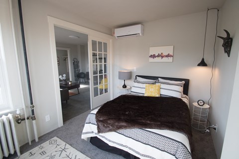 a bedroom with a bed in a room