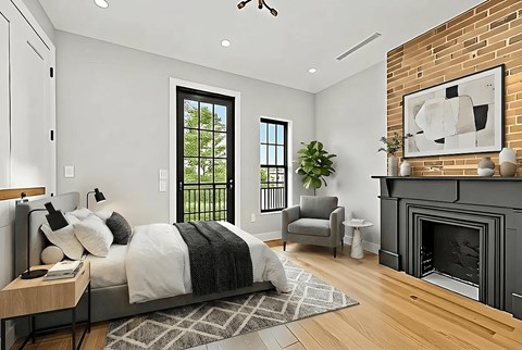 A modern bedroom with a fireplace and a large bed.