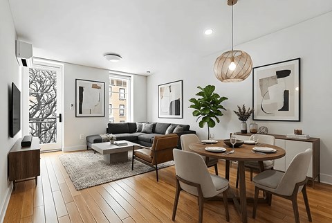 A modern living room with a dining table set for two.
