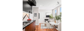 a kitchen and living room with a table and chairs