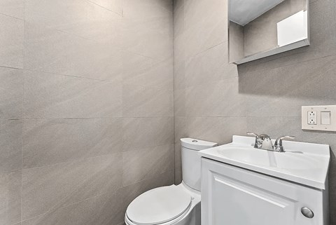 A white toilet and sink in a bathroom.