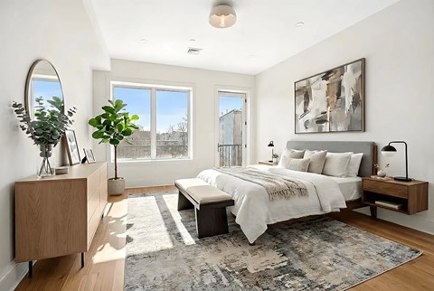 A bedroom with a large bed and a large window.