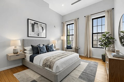 A bedroom with a large bed and a mirror on the wall.
