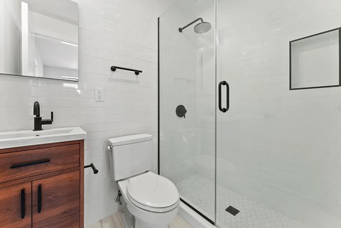 A white toilet sits next to a sink in a bathroom.