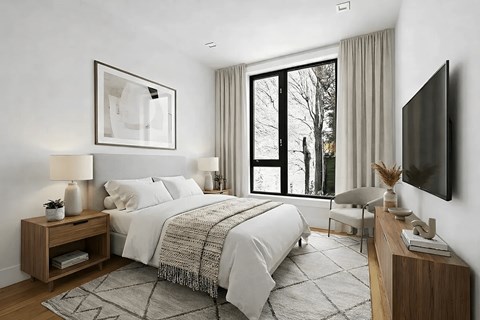 A modern bedroom with a large bed, a flat-screen TV, and a large window.