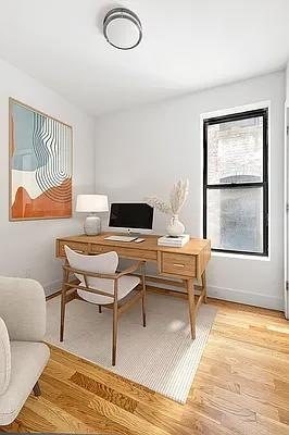A room with a desk and a chair.
