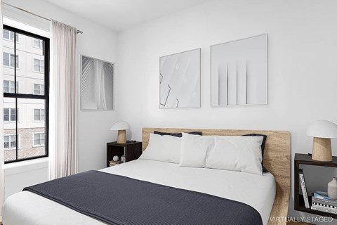 A bedroom with a large bed and two nightstands.