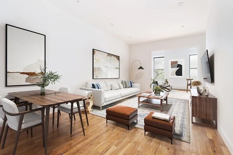 A modern living room with a wooden floor and furniture.