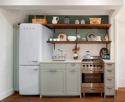 A kitchen with a white refrigerator and a stove top oven.