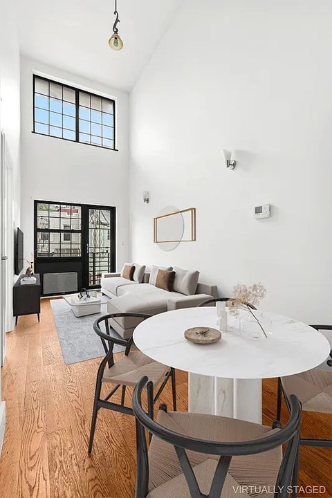 A living room with a white table and chairs.