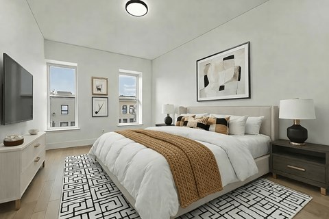 A bedroom with a large bed and a television.