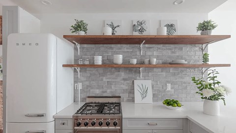 A modern kitchen with a white refrigerator and a white stove top oven.