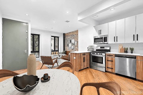 A modern kitchen with wooden cabinets and stainless steel appliances.