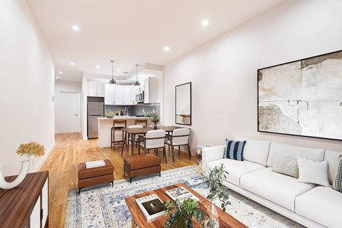 A modern living room with a white sofa and a coffee table.