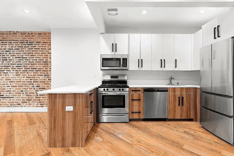 A modern kitchen with wooden cabinets and stainless steel appliances.