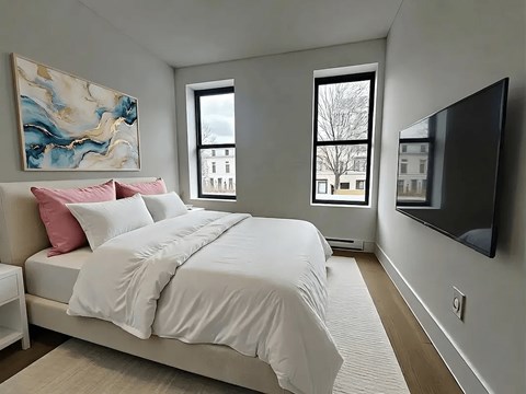 A bedroom with a large bed and a painting on the wall.