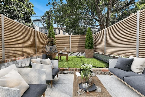 A patio with a table, chairs, and a couch.