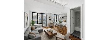 A living room with a grey couch and a coffee table.
