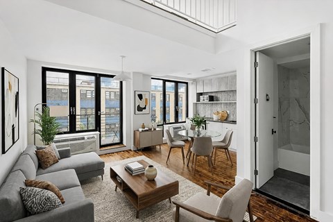 A living room with a grey couch and a coffee table.