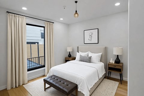 A bedroom with a large bed, a balcony with a view of a pool, and a framed picture on the wall.