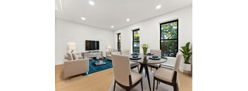 A modern living room with a glass table and chairs.