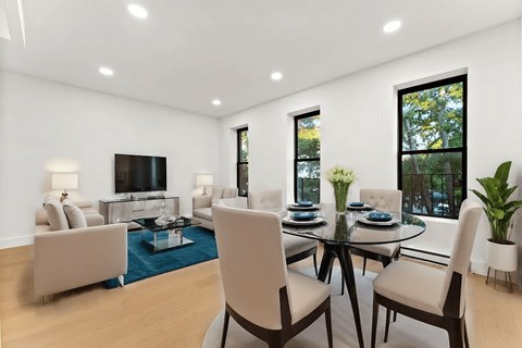 A modern living room with a glass table and chairs.