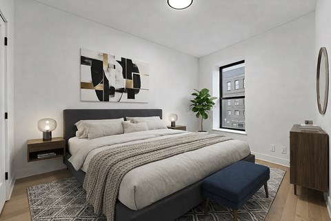 A bedroom with a large bed and a painting on the wall.