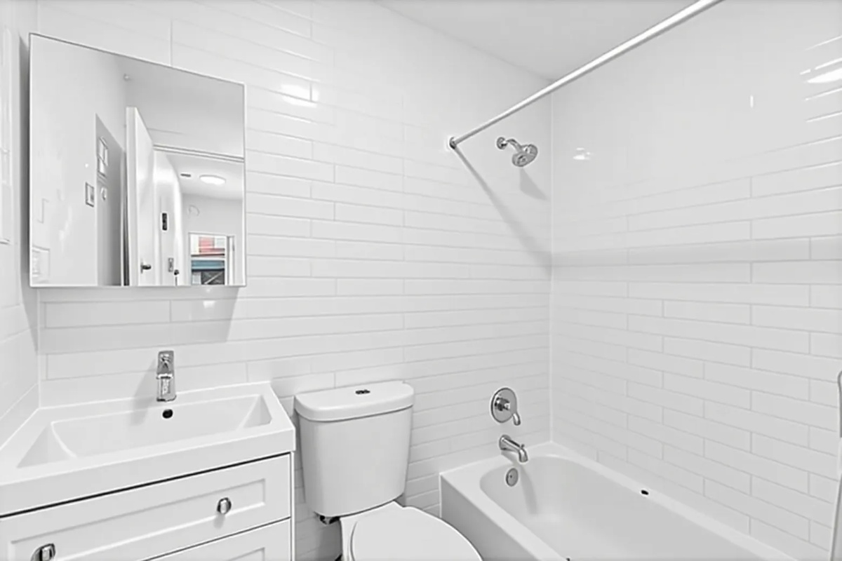 A white bathroom with a sink, toilet, and bathtub.