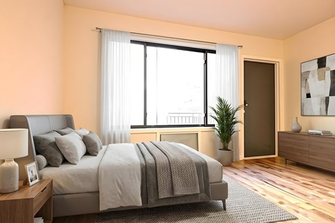 A bedroom with a large bed, a nightstand with a lamp, a plant, and a painting on the wall.