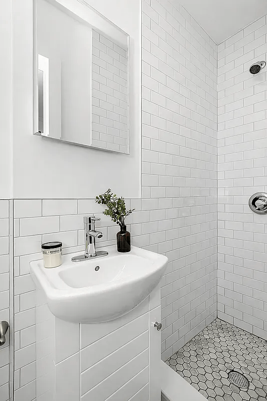 A white sink in a tiled bathroom.