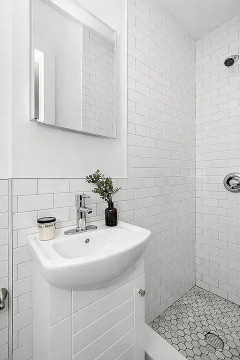 A white sink in a tiled bathroom.