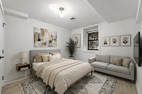 A bedroom with a large bed and a couch.