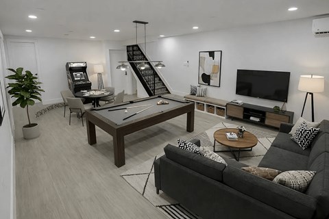 A modern living room with a black couch and a wooden coffee table.