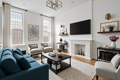 A living room with a blue couch and a fireplace.