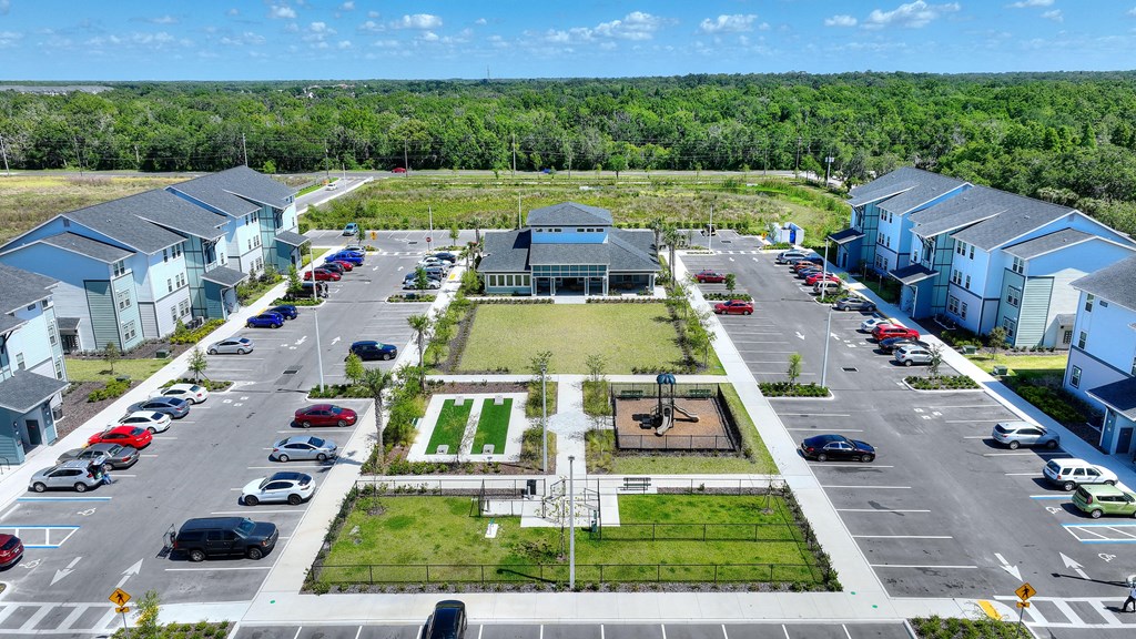an aerial view of a neighborhood with cars parked in a parking lot