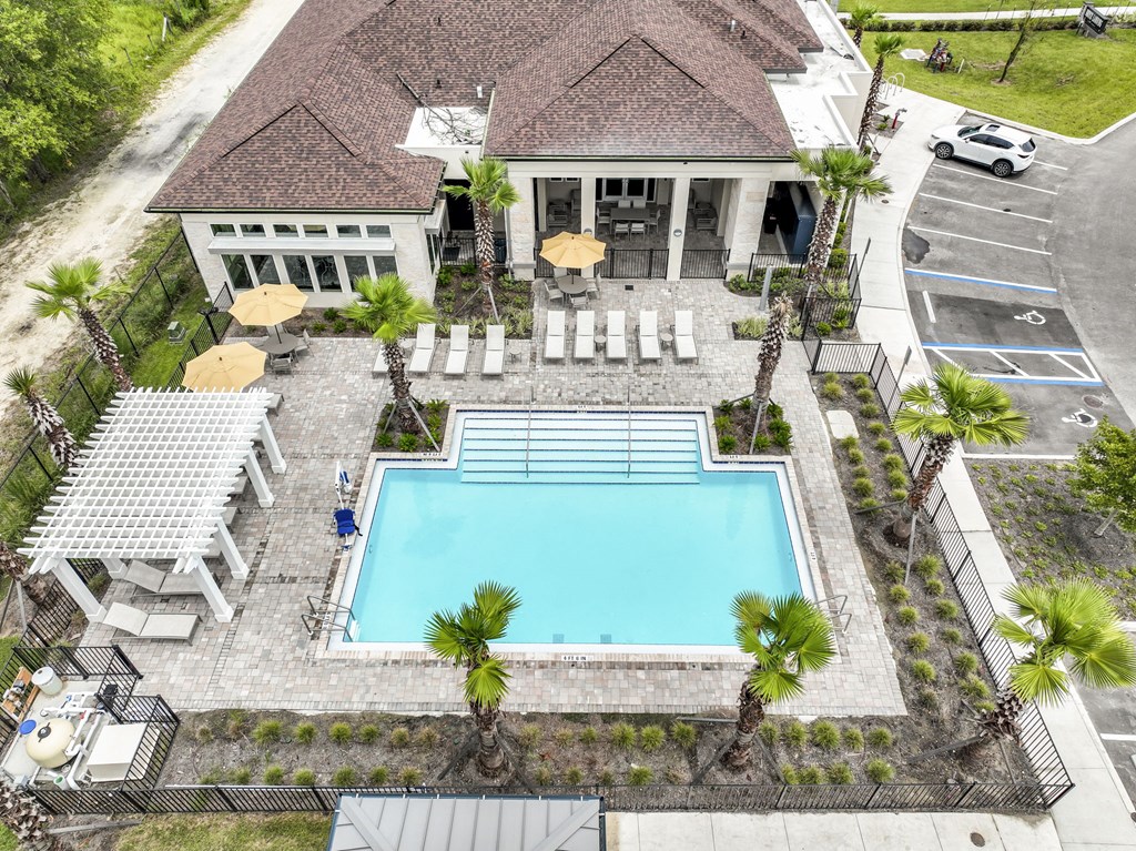 a large swimming pool in front of a house