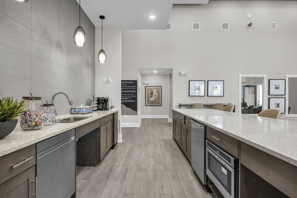 a large kitchen with stainless steel appliances and counter tops