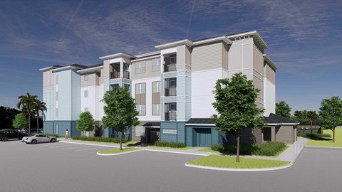 A modern apartment building with a parking lot in front.