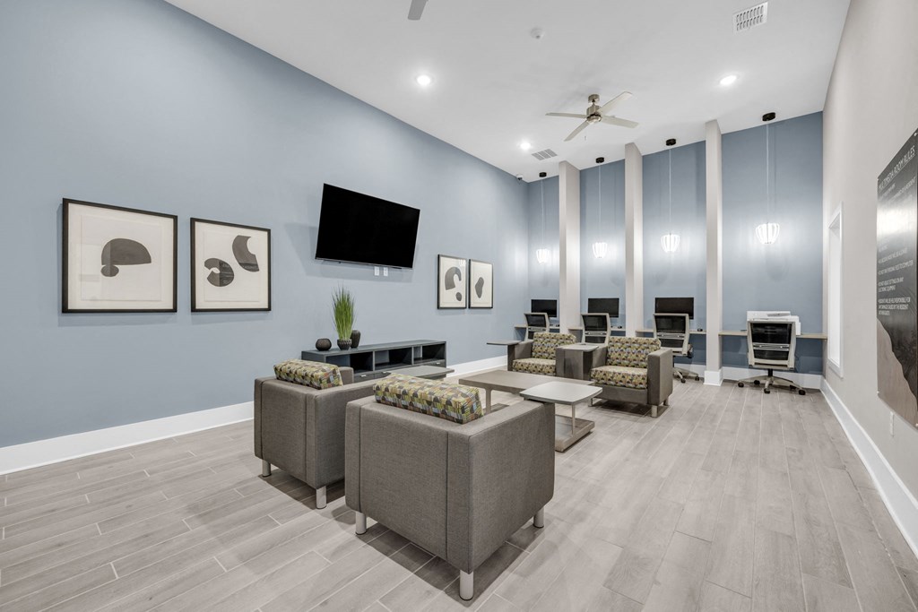 a living room with couches and chairs and a tv