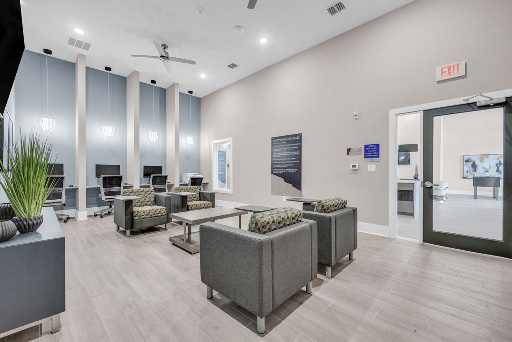a lobby with couches and chairs and a glass door