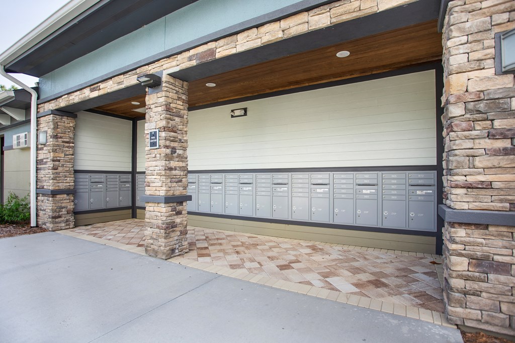 A garage door is closed and there are 11 lockers on the wall.