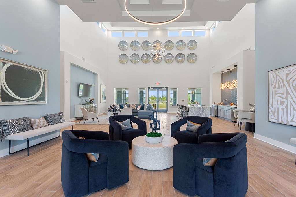 a living room with blue chairs and a white coffee table