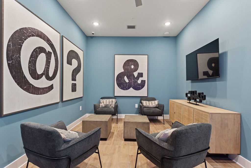 a waiting room with chairs and paintings on the wall